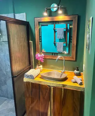 a bathroom with a sink and a mirror at Java blue banana in Santa Cruz