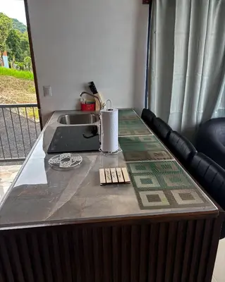 a kitchen counter with a sink and a counter top with a counter at Monteverde Sunset House in Cebadilla