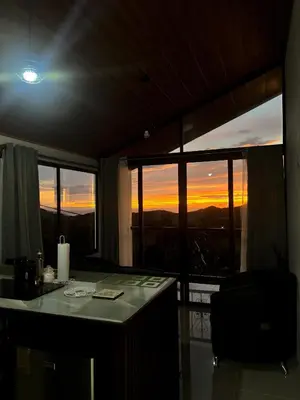 a room with a desk with a view of the sunset at Monteverde Sunset House in Cebadilla