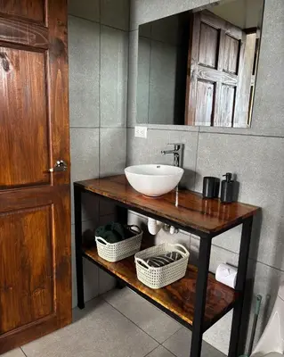 a bathroom with a sink and a mirror at Monteverde Sunset House in Cebadilla