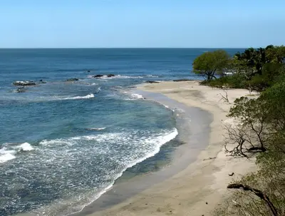 a sandy beach with the ocean in the background at Casas Pelicano in Playa Junquillal
