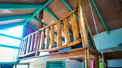 a wooden staircase in a room with a ceiling at Finca Buena Vista in Turrialba