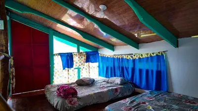 a bedroom with two beds and a window at Finca Buena Vista in Turrialba