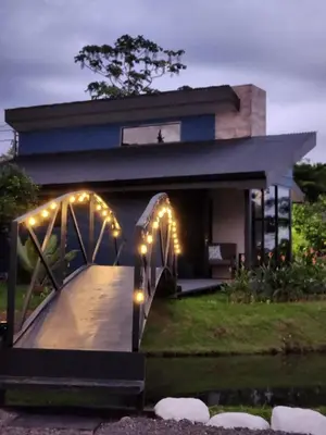 a house with lights on the front of it at Casa del Lago in Bijagua