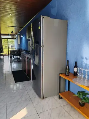 a large stainless steel refrigerator in a kitchen at YAIZA HOUSE Jaco in Jacó