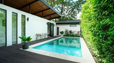a swimming pool in the backyard of a house at 3BR Peaceful Retreat Walking Distance to Beach in Tamarindo