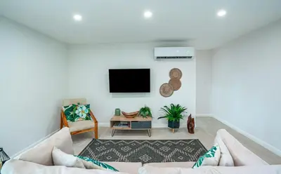 a living room with a couch and a tv at 3BR Peaceful Retreat Walking Distance to Beach in Tamarindo