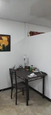 a desk in a room with a table in the corner at La casita de Antonio en Sarapiqui in Llano Grande
