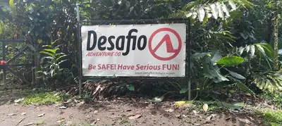 a sign for a school in a garden at La casita de Antonio en Sarapiqui in Llano Grande