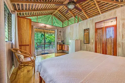 a bedroom with a white bed in a room with a window at Chalet Jardin Tropical in Ojochal