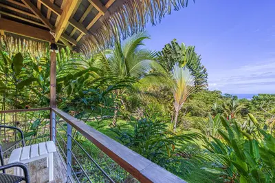 a balcony of a resort with a view of the ocean at Chalet Jardin Tropical in Ojochal