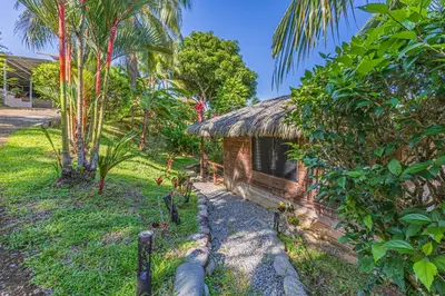 a small building in the middle of a garden at Chalet Jardin Tropical in Ojochal