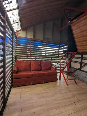 a couch sitting in the middle of a room at Alojamiento el Mirador in Tapantí