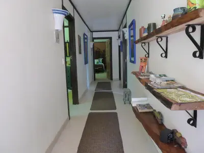 a hallway with long floors and shelves in a room at Lucky Bug Bed And Breakfast in Nuevo Arenal