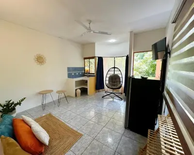 a living room with a couch and a desk at Hotel Nany in Brasilito