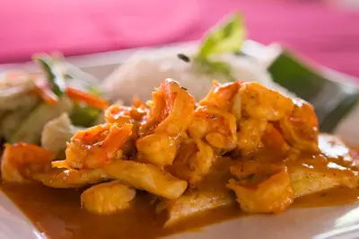 a plate of food with shrimp and sauce at Hotel Nany in Brasilito