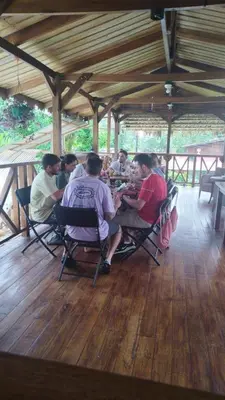a group of people sitting around a table at Liahs tortuguero in Tortuguero