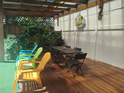 a patio with a table and chairs on a deck at Liahs tortuguero in Tortuguero