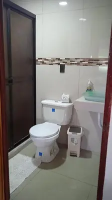 a bathroom with a toilet and a sink at Liahs tortuguero in Tortuguero