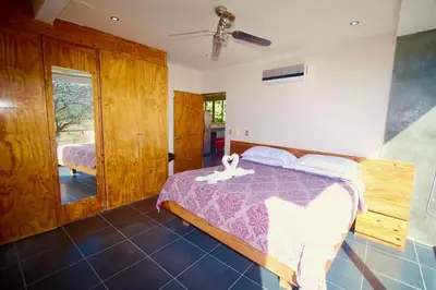 a bedroom with a bed with a purple comforter at Catalina World Class Viewslocationservice! in Sámara