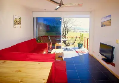 a living room with a red couch and a tv at Catalina World Class Viewslocationservice! in Sámara