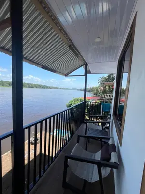 a balcony with a view of the water at Apartamento Lirios del Río in Tortuguero