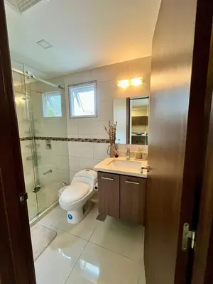 a bathroom with a toilet and a sink and a shower at Refugio Caribeño in Puerto Limón
