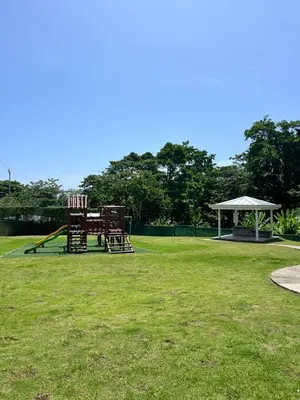 a park with two chairs and a playground at Refugio Caribeño in Puerto Limón