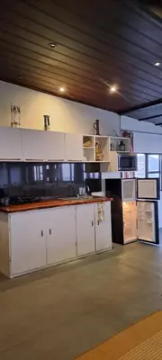 a large kitchen with white cabinets and appliances at Apartamento Céntrico con Vista in Heredia