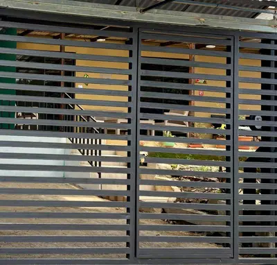 a wall of blinds on a building with a window at Paraiso En-suite #3 in Parrita
