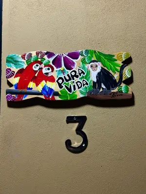 a clock on a wall with a monkey on it at Paraiso En-suite #3 in Parrita