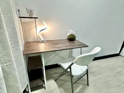 a desk with a lamp and a chair in a room at Paraiso En-suite #3 in Parrita