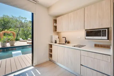 a kitchen with a view of a swimming pool at The Bungalows Flamingo - 10 Unit Boutique Hotel in Playa Flamingo