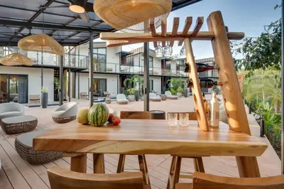 a wooden table with fruit on top of a patio at The Bungalows Flamingo - 10 Unit Boutique Hotel in Playa Flamingo