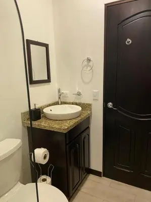 a bathroom with a sink and a toilet and a mirror at Casa grano de oro in Turín