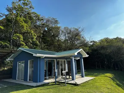 a tiny house with a blue roof in a yard at Casa grano de oro in Turín