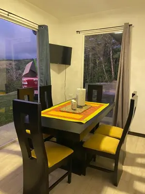 a dining room table and chairs with a table and a window at Casa grano de oro in Turín