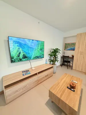 a living room with a large flat screen tv on the wall at Viva Jaco Unit 0605 in Jacó
