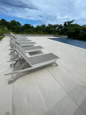 a row of lounge chairs on the roof of a building at Welcome to paradise!Reserva Conchal, Solaris, C-1A in Playa Conchal
