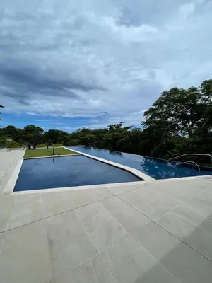 an empty swimming pool with trees in the background at Welcome to paradise!Reserva Conchal, Solaris, C-1A in Playa Conchal