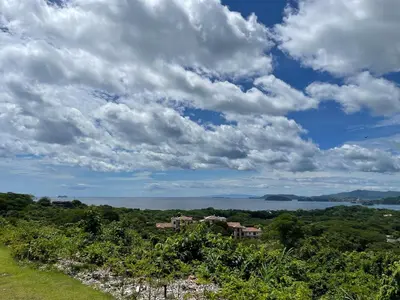 a view of a house on a hill with a cloudy sky at Welcome to paradise!Reserva Conchal, Solaris, C-1A in Playa Conchal