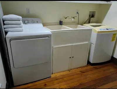 a kitchen with a sink and a washing machine at Mountain View Near SJO Airport Fast WiFi in Alajuela City