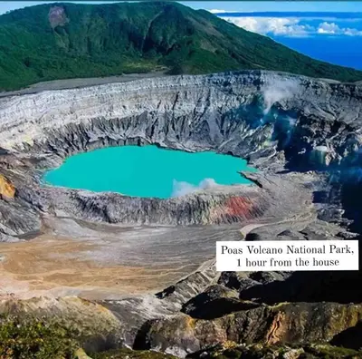 a mountain crater with a blue lake in it at Mountain View Near SJO Airport Fast WiFi in Alajuela City