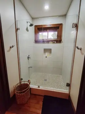 a shower with a glass door in a bathroom at Mountain View Near SJO Airport Fast WiFi in Alajuela City