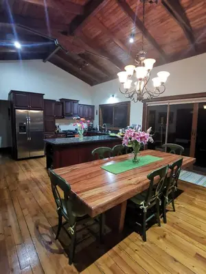 a large kitchen with a wooden table and chairs at Mountain View Near SJO Airport Fast WiFi in Alajuela City