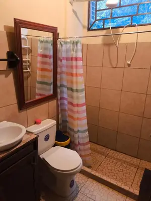 a bathroom with a toilet and a sink and a mirror at Cabaña escondida Venecia in Venecia