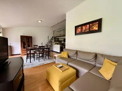 a living room with a couch and a table at CR MARIPOSA RENTALS lakeview, spacious penthouse with office, pool, gym, Jacuzzi in Santa Ana