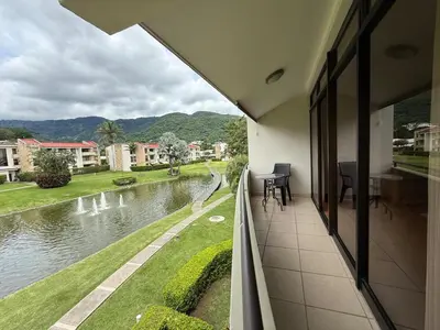 a balcony of a building with a view of a river at CR MARIPOSA RENTALS lakeview, spacious penthouse with office, pool, gym, Jacuzzi in Santa Ana