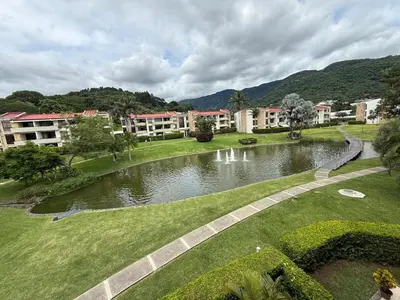 a park with a pond in front of some buildings at CR MARIPOSA RENTALS lakeview, spacious penthouse with office, pool, gym, Jacuzzi in Santa Ana
