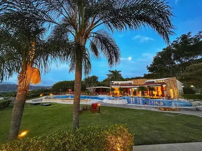 a resort with a palm tree and a swimming pool at CR MARIPOSA RENTALS lakeview, spacious penthouse with office, pool, gym, Jacuzzi in Santa Ana
